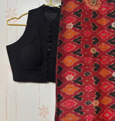 Black cotton sleeveless blouse with high neck