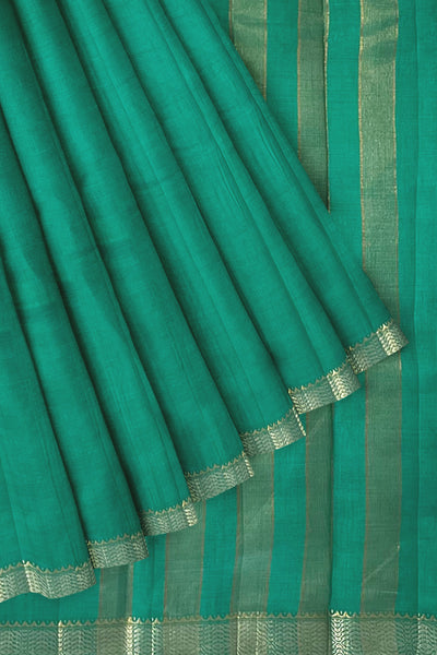 Emerald green tussar silk saree with gold and dull gold zari