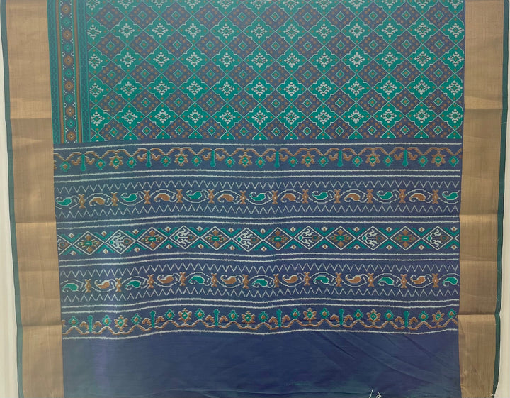 Green and violet Patola print silk saree with zari border