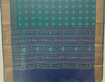 Green and violet Patola print silk saree with zari border